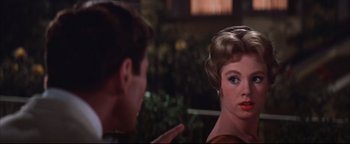 Movie still from “The Music Man” (1962), directed by Morton DaCosta – A man and a woman talking to each other; Close Up shot, Over the shoulder angle