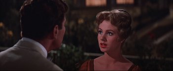 Movie still from “The Music Man” (1962), directed by Morton DaCosta – A man and a woman talking to each other; Close Up shot, Over the shoulder angle