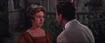 Movie still from “The Music Man” (1962), directed by Morton DaCosta – A man and a woman talking to each other; Close Up shot, Over the shoulder angle