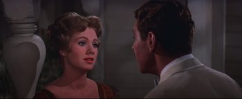 Movie still from “The Music Man” (1962), directed by Morton DaCosta – A man and a woman looking at one another; Close Up shot, Over the shoulder angle