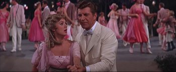 Movie still from “The Music Man” (1962), directed by Morton DaCosta – A man and a woman dancing in front of a group of people; Medium shot, Low angle