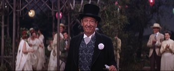 Movie still from “The Music Man” (1962), directed by Morton DaCosta – An old man in a top hat and a suit; Medium shot, Over the shoulder angle