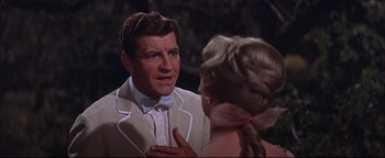 Movie still from “The Music Man” (1962), directed by Morton DaCosta – A man and a woman talking to each other; Close Up shot, Over the shoulder angle