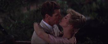 Movie still from “The Music Man” (1962), directed by Morton DaCosta – A man and a woman are kissing in the dark; Close Up shot, Low angle