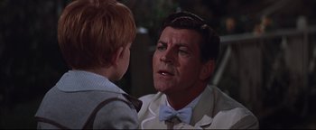 Movie still from “The Music Man” (1962), directed by Morton DaCosta – An older man and a young boy talking; Close Up shot, Over the shoulder angle