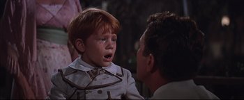 Movie still from “The Music Man” (1962), directed by Morton DaCosta – A little boy is crying while talking to a man; Close Up shot, High angle