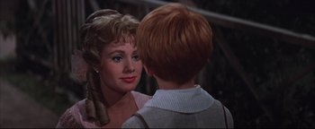 Movie still from “The Music Man” (1962), directed by Morton DaCosta – A young woman talking to a young man in front of a building; Close Up shot, Over the shoulder angle