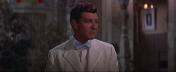 Movie still from “The Music Man” (1962), directed by Morton DaCosta – A man in a white suit with a bow tie; Close Up shot, Low angle