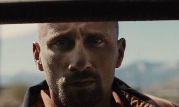 Movie still from “The Mustang” (2019), directed by Laure de Clermont-Tonnerre – A person looking at the camera; Close Up shot, Low angle