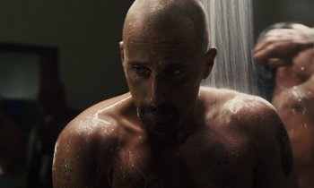 Movie still from “The Mustang” (2019), directed by Laure de Clermont-Tonnerre – A man with a beard is taking a shower; Close Up shot, Low angle