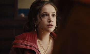 Movie still from “The Mustang” (2019), directed by Laure de Clermont-Tonnerre – A young woman wearing a red leather jacket and gold jewelry; Close Up shot, Over the shoulder angle