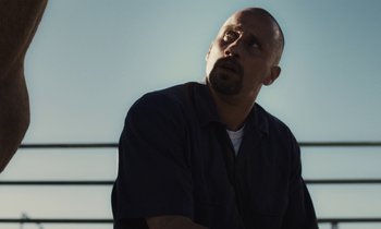 Movie still from “The Mustang” (2019), directed by Laure de Clermont-Tonnerre – A man with a goatee looking up at the sky; Close Up shot, Low angle