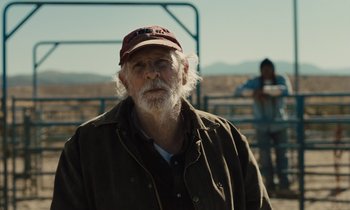 Movie still from “The Mustang” (2019), directed by Laure de Clermont-Tonnerre – An old man with a beard wearing a hat; Medium shot, Over the shoulder angle
