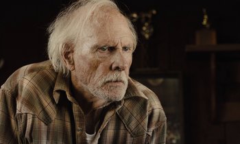 Movie still from “The Mustang” (2019), directed by Laure de Clermont-Tonnerre – An old man with a white beard is looking at the camera; Close Up shot, Over the shoulder angle