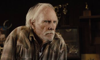 Movie still from “The Mustang” (2019), directed by Laure de Clermont-Tonnerre – An older man with a beard and a plaid shirt; Close Up shot, Over the shoulder angle