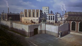 Movie still from “Naked Gun 33 1/3: The Final Insult” (1994), directed by Peter Segal – A painting of an industrial area with buildings and a tunnel; Extreme Wide shot, High angle