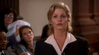 Movie still from “Naked Gun 33 1/3: The Final Insult” (1994), directed by Peter Segal – A person wearing a suit and tie; Close Up shot, Low angle