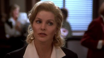 Movie still from “Naked Gun 33 1/3: The Final Insult” (1994), directed by Peter Segal – A person wearing a suit and tie; Close Up shot, Over the shoulder angle