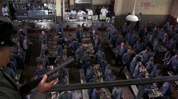Movie still from “Naked Gun 33 1/3: The Final Insult” (1994), directed by Peter Segal – A large group of people in a large kitchen; Wide shot, High angle