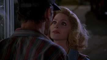 Movie still from “Naked Gun 33 1/3: The Final Insult” (1994), directed by Peter Segal – A man and a woman looking into each other's eyes; Close Up shot, Over the shoulder angle