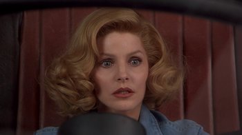 Movie still from “Naked Gun 33 1/3: The Final Insult” (1994), directed by Peter Segal – A person wearing a blue shirt; Close Up shot, Low angle