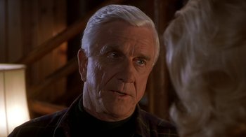Movie still from “Naked Gun 33 1/3: The Final Insult” (1994), directed by Peter Segal – An older man with white hair talking to a woman; Close Up shot, Over the shoulder angle