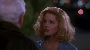 Movie still from “Naked Gun 33 1/3: The Final Insult” (1994), directed by Peter Segal – A person wearing a blue shirt; Close Up shot, Over the shoulder angle