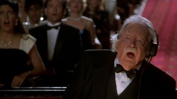 Movie still from “Naked Gun 33 1/3: The Final Insult” (1994), directed by Peter Segal – An old man in a tuxedo is yawning; Close Up shot, Low angle