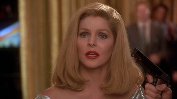 Movie still from “Naked Gun 33 1/3: The Final Insult” (1994), directed by Peter Segal – A person with long hair; Close Up shot, Over the shoulder angle