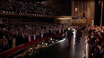Movie still from “Naked Gun 33 1/3: The Final Insult” (1994), directed by Peter Segal – A crowd of people in an auditorium watching a performance; Extreme Wide shot, High angle