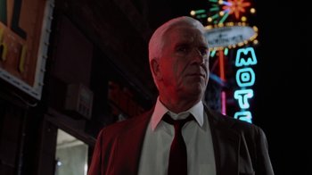 Movie still from “The Naked Gun: From the Files of Police Squad!” (1988), directed by David Zucker – An older man wearing a suit and a tie; Close Up shot, Low angle