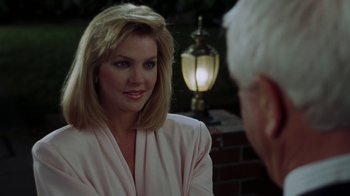 Movie still from “The Naked Gun: From the Files of Police Squad!” (1988), directed by David Zucker – A woman wearing a white shirt is talking to an older man; Close Up shot, Over the shoulder angle