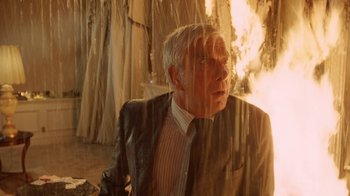 Movie still from “The Naked Gun: From the Files of Police Squad!” (1988), directed by David Zucker – An older man wearing a suit and a tie; Medium shot, Low angle