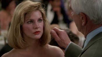 Movie still from “The Naked Gun: From the Files of Police Squad!” (1988), directed by David Zucker – A woman is getting her hair done by a man; Close Up shot, Over the shoulder angle