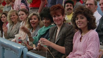 Movie still from “The Naked Gun: From the Files of Police Squad!” (1988), directed by David Zucker – A group of people sitting next to each other; Medium shot, High angle