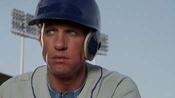 Movie still from “The Naked Gun: From the Files of Police Squad!” (1988), directed by David Zucker – A baseball player wearing a helmet; Close Up shot, Low angle