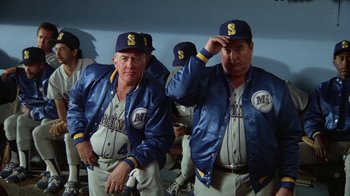 Movie still from “The Naked Gun: From the Files of Police Squad!” (1988), directed by David Zucker – A couple of baseball players are sitting in a dugout; Medium shot, Low angle