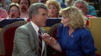 Movie still from “The Naked Gun: From the Files of Police Squad!” (1988), directed by David Zucker – A man and a woman holding each others hands; Medium shot, Over the shoulder angle