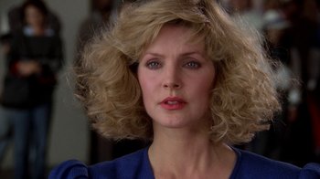 Movie still from “The Naked Gun: From the Files of Police Squad!” (1988), directed by David Zucker – A person wearing a blue shirt; Close Up shot, Low angle