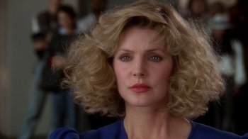 Movie still from “The Naked Gun: From the Files of Police Squad!” (1988), directed by David Zucker – A person wearing a blue shirt; Close Up shot, Low angle