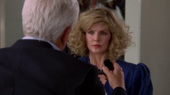 Movie still from “The Naked Gun: From the Files of Police Squad!” (1988), directed by David Zucker – An older woman is getting her hair brushed by an older man; Close Up shot, Over the shoulder angle