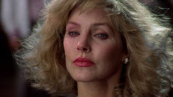 Movie still from “The Naked Gun: From the Files of Police Squad!” (1988), directed by David Zucker – A person with long blonde hair; Close Up shot, Low angle