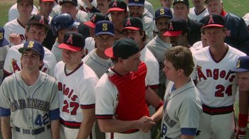 Movie still from “The Naked Gun: From the Files of Police Squad!” (1988), directed by David Zucker – A group of baseball players standing next to each other on a field; Medium shot, Over the shoulder angle