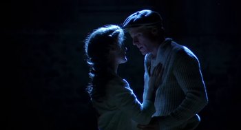 Movie still from “The Natural” (1984), directed by Barry Levinson – A man and a woman standing next to each other in the dark; Close Up shot, Overhead angle