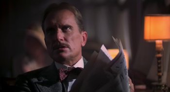 Movie still from “The Natural” (1984), directed by Barry Levinson – A person wearing a suit and tie; Close Up shot, Low angle