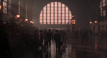 A group of people walking through a train station
