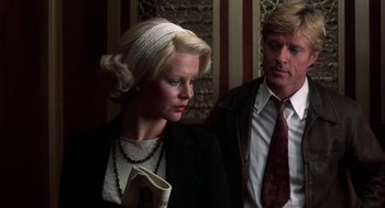 Movie still from “The Natural” (1984), directed by Barry Levinson – A man and a woman standing next to each other; Close Up shot, Low angle