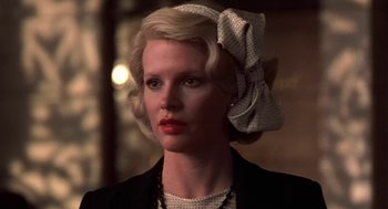 Movie still from “The Natural” (1984), directed by Barry Levinson – A person wearing a suit and tie; Close Up shot, Low angle