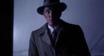 Movie still from “The Natural” (1984), directed by Barry Levinson – A man wearing a hat and a coat; Close Up shot, Low angle