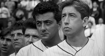 Movie still from “The Natural” (1984), directed by Barry Levinson – A black and white photo of three baseball players; Close Up shot, Over the shoulder angle